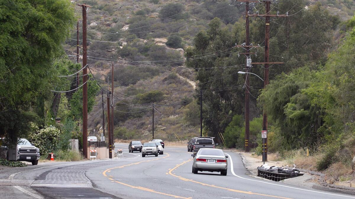 The push is on in Laguna Beach to underground utility poles and wires, seen in this 2016 photo of Laguna Canyon Road. The City Council on Tuesday will consider a host of steps, including purchasing credits from other cities.