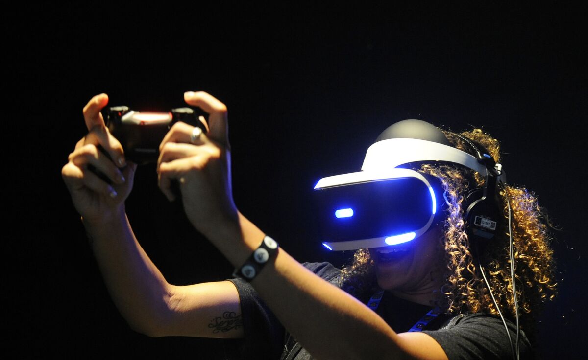 Sianna Hasenberg plays with Sony's PlayStation VR at the Electronic Entertainment Expo in 2015. The headset is due for release in 2016.