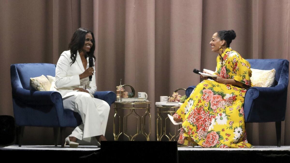 Former First Lady Michelle Obama, left, and Tracee Ellis Ross at the Forum in Los Angeles discussing Obama's memoir "Becoming."