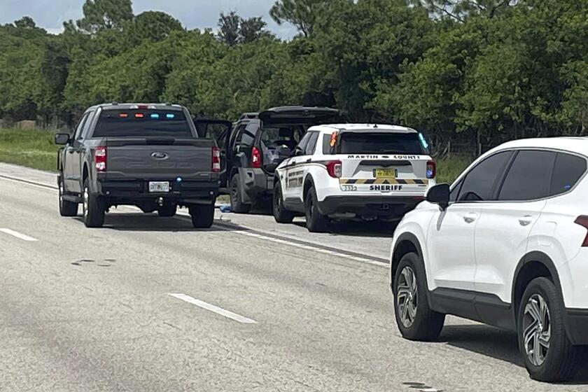 Esta foto proporcionada por la comisaría del condado Martin muestra vehículos de la comisaría que rodean a una camioneta SUV en la carretera interestatal 95 en dirección norte, el domingo 15 de septiembre de 2024, en el condado Martin, Florida. (Comisaría del condado Martin vía AP)