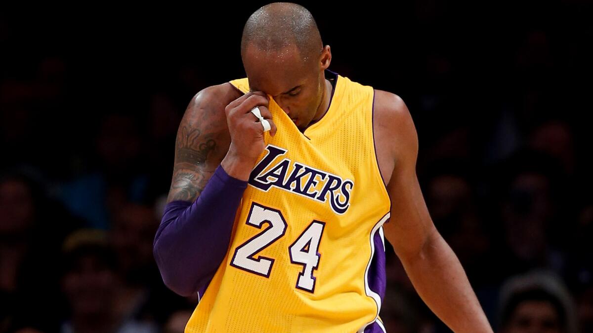 Lakers forward Kobe Bryant catches his breath during a break in the action against the Spurs on Friday night at Staples Center.