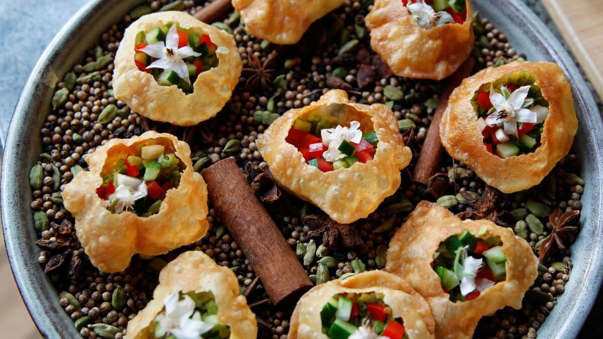 Chef TK Kolanko prepared these pani puri appetizers at the May 4 Artisan Table dinner at A. R. Valentien. The Indian street food dish is simple but packs a flavorful punch: crispy shells filled with diced, mildly-spiced vegetables and mint water.