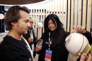 Frankie Reina, left, gets an eye scan with the help of Myra Vides, center.