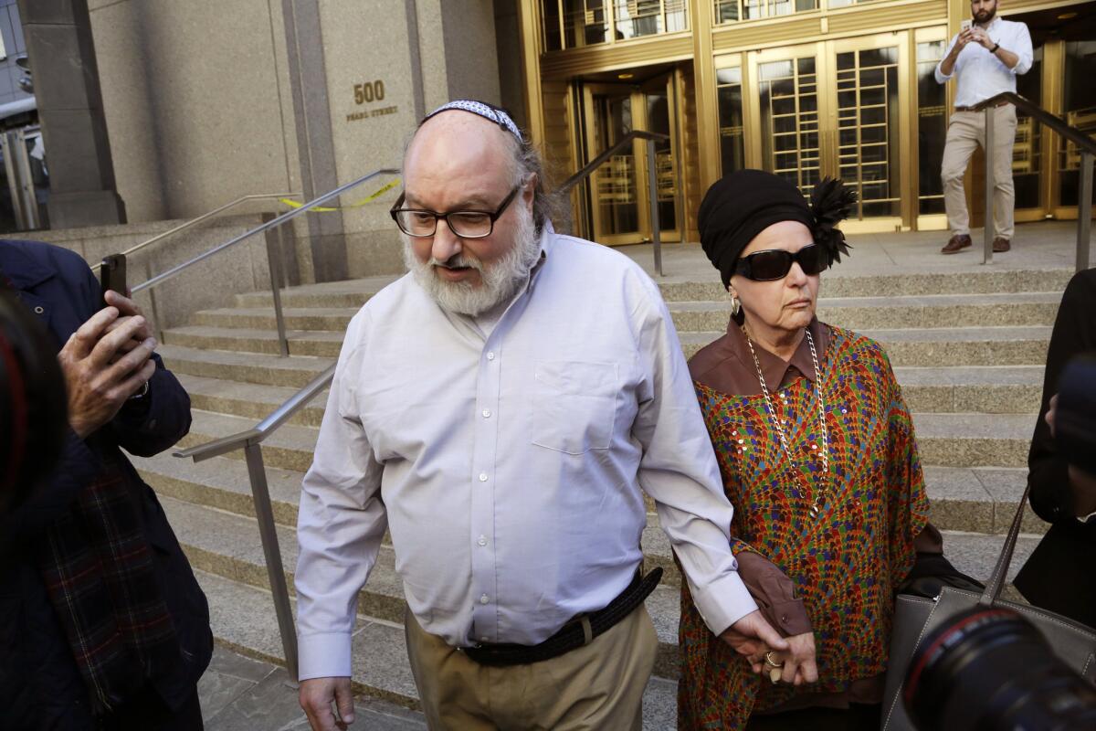 Forrmer U.S. intelligence analyst Jonathan Pollard, who spent three decades in prison for spying for Israel, leaves the federal courthouse in New York on Friday with his wife, Esther.