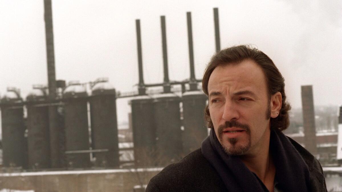 Springsteen stands in front of the "Jenny," a shut down steel furnace in Youngstown, Ohio, on Jan. 13, 1996.