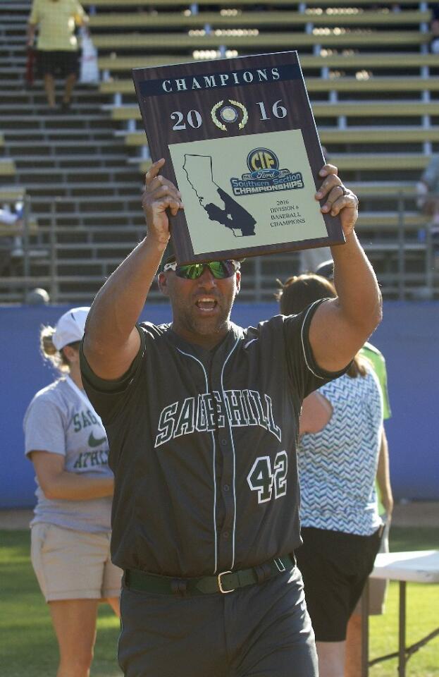 Sage Hill School head coach Dominic Campeau hoists up the championship plaque after the Lightning beat Crean Lutheran, 9-0, in the CIF-SS Division 6 baseball championship game at UCR Sports Complex in Riverside on Saturday.