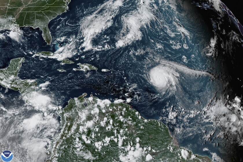 Hurricane Sam, center right, churns in the Atlantic Ocean on Sept. 27, 2021.