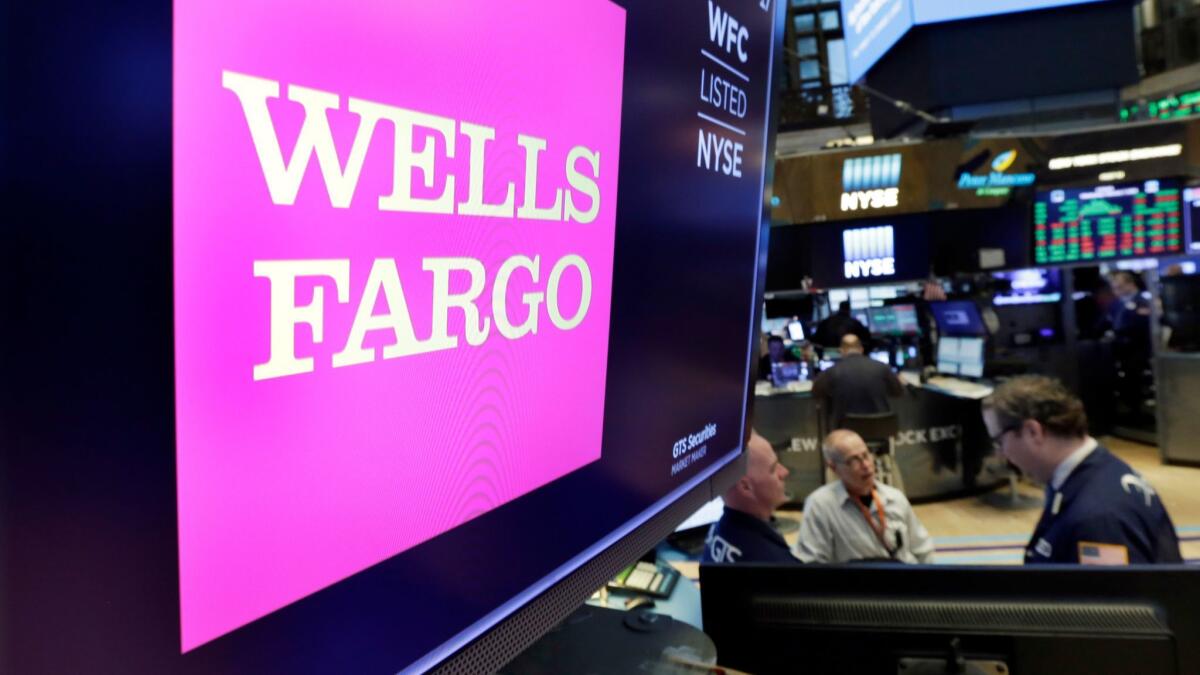 The Wells Fargo logo appears above a trading post on the floor of the New York Stock Exchange.