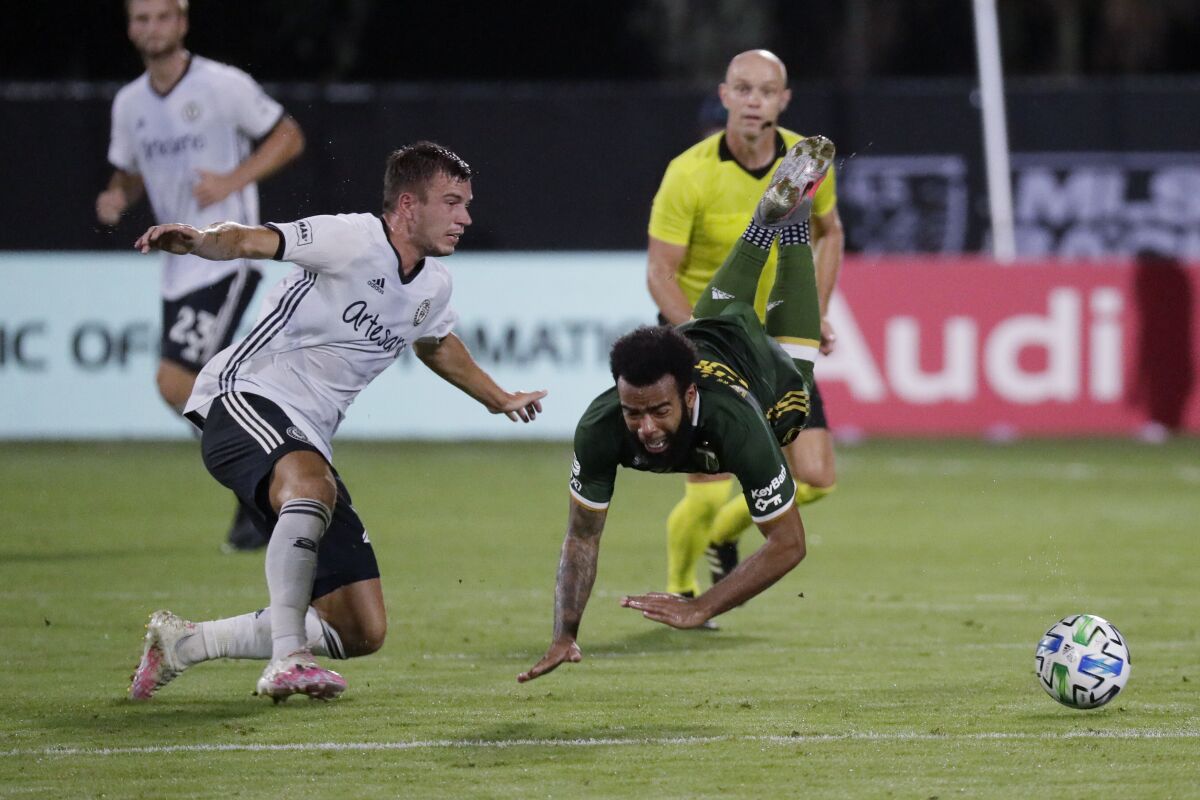 Philadelphia Union defender Kai Wagner, left, and Portland Timbers midfielder Eryk Williamson collide during the first half of an MLS soccer match, Wednesday, Aug. 5, 2020, in Kissimmee, Fla. (AP Photo/John Raoux)