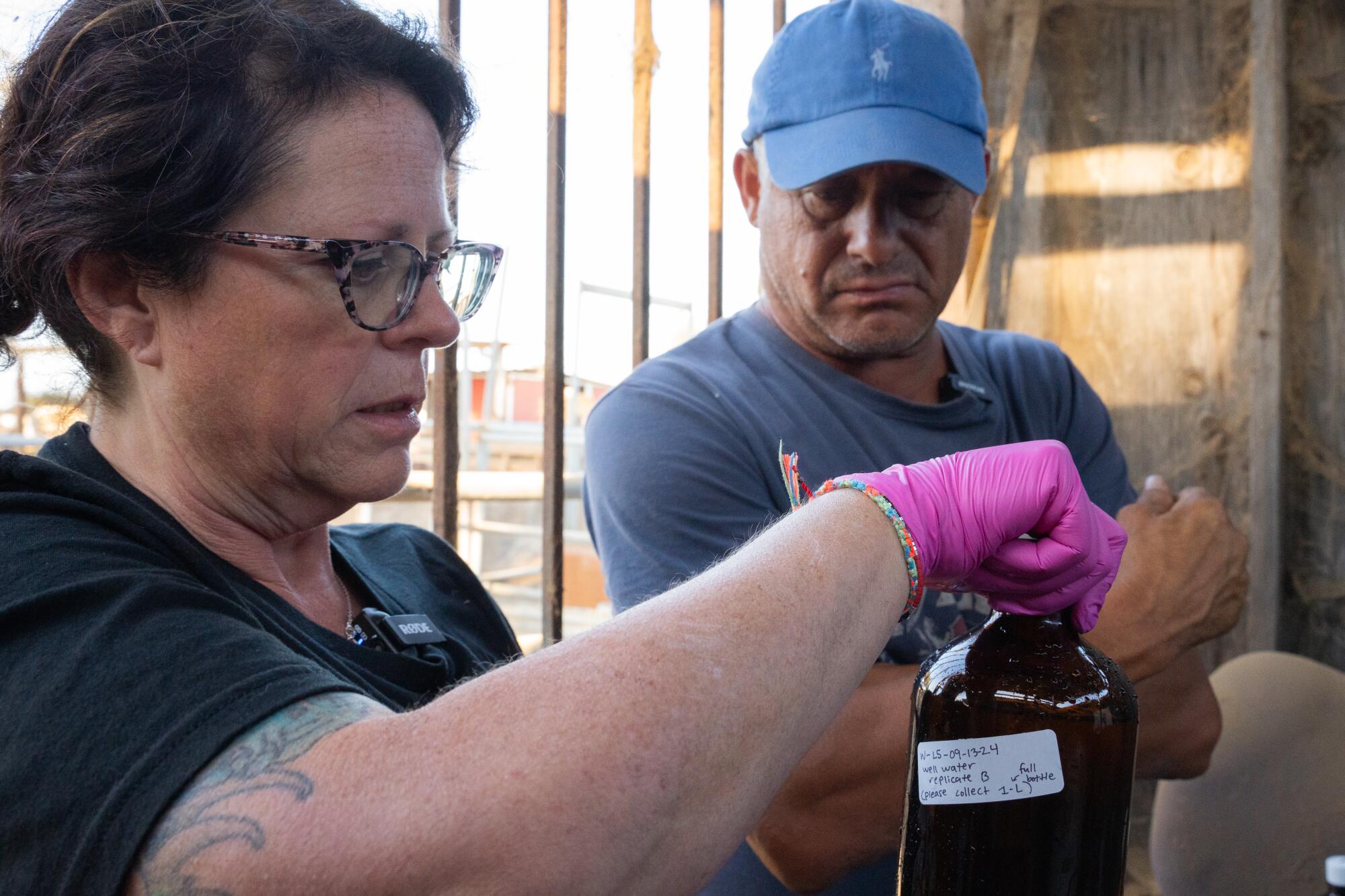 Paula Granados tests the groundwater at Gabriel Uribe's property.