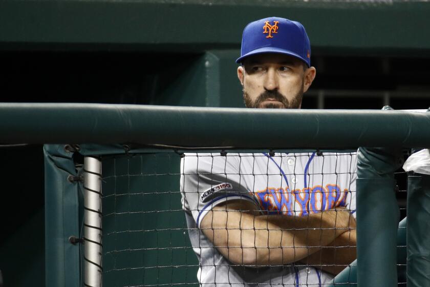 FILE - In this May 15, 2019, file photo, New York Mets manager Mickey Callaway stands in the dugout in the eighth inning of a baseball game against the Washington Nationals, in Washington. Callaway was fired by the New York Mets on Thursday, Oct. 3, 2019, after missing the playoffs in both his seasons as manager.(AP Photo/Patrick Semansky, File)