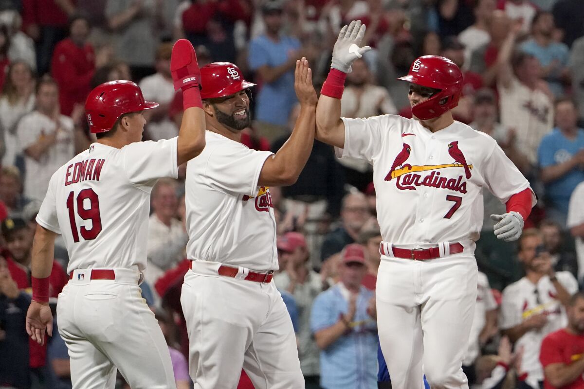 St. Louis Cardinals' Andrew Knizner (7) is congratulated by teammates Albert Pujols and Tommy Edman (19) after hitting a three-run home run during the fourth inning of a baseball game against the Kansas City Royals Tuesday, April 12, 2022, in St. Louis. (AP Photo/Jeff Roberson)