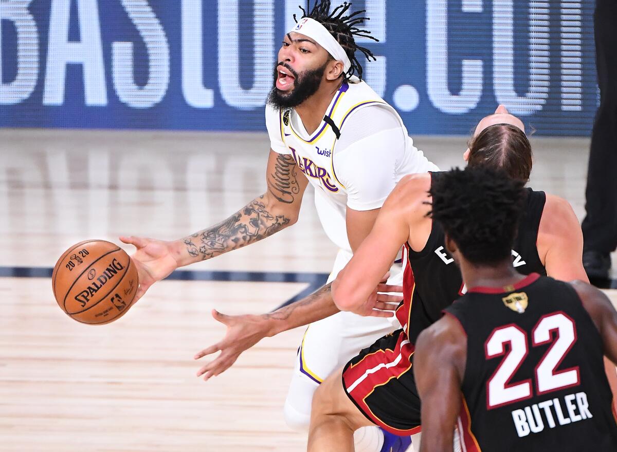 Lakers forward Anthony Davis charges into Heat center Kelly Olynyk for a foul during Game 3 on Sunday night.