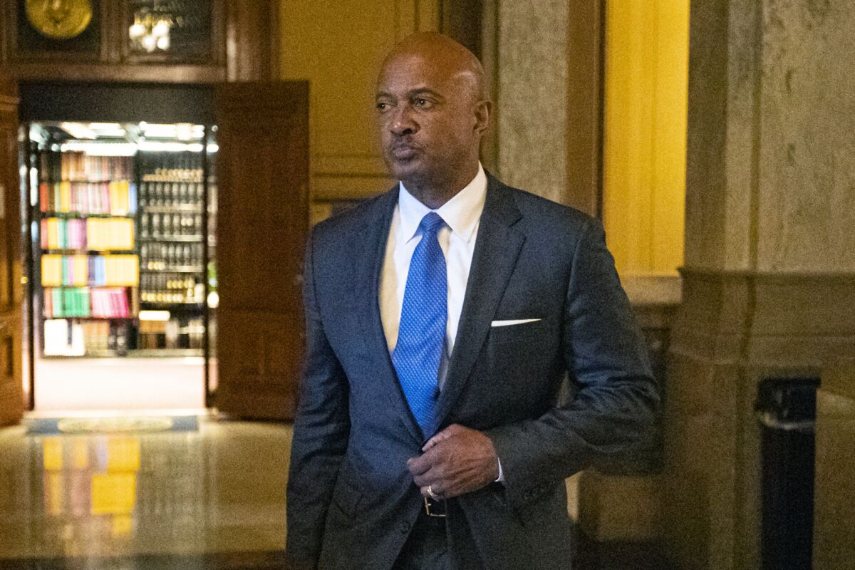 FILE - In this Oct. 23, 2019, file photo, Indiana Attorney General Curtis Hill arrives for a hearing at the state Supreme Court at the Statehouse in Indianapolis. A 60-day law license suspension is being recommended for Hill after allegations that he grabbed the buttocks of state Rep. Mara Candelaria Reardon, and inappropriately touched three other women during a party. The recommendation filed Friday, Feb. 14, 2020, with the state Supreme Court puts the Republican Hill's ability to remain as state government's top lawyer in jeopardy as he must have a law license to hold the position. It wasn't immediately clear how a temporary suspension would affect his status. (AP Photo/Michael Conroy, File)