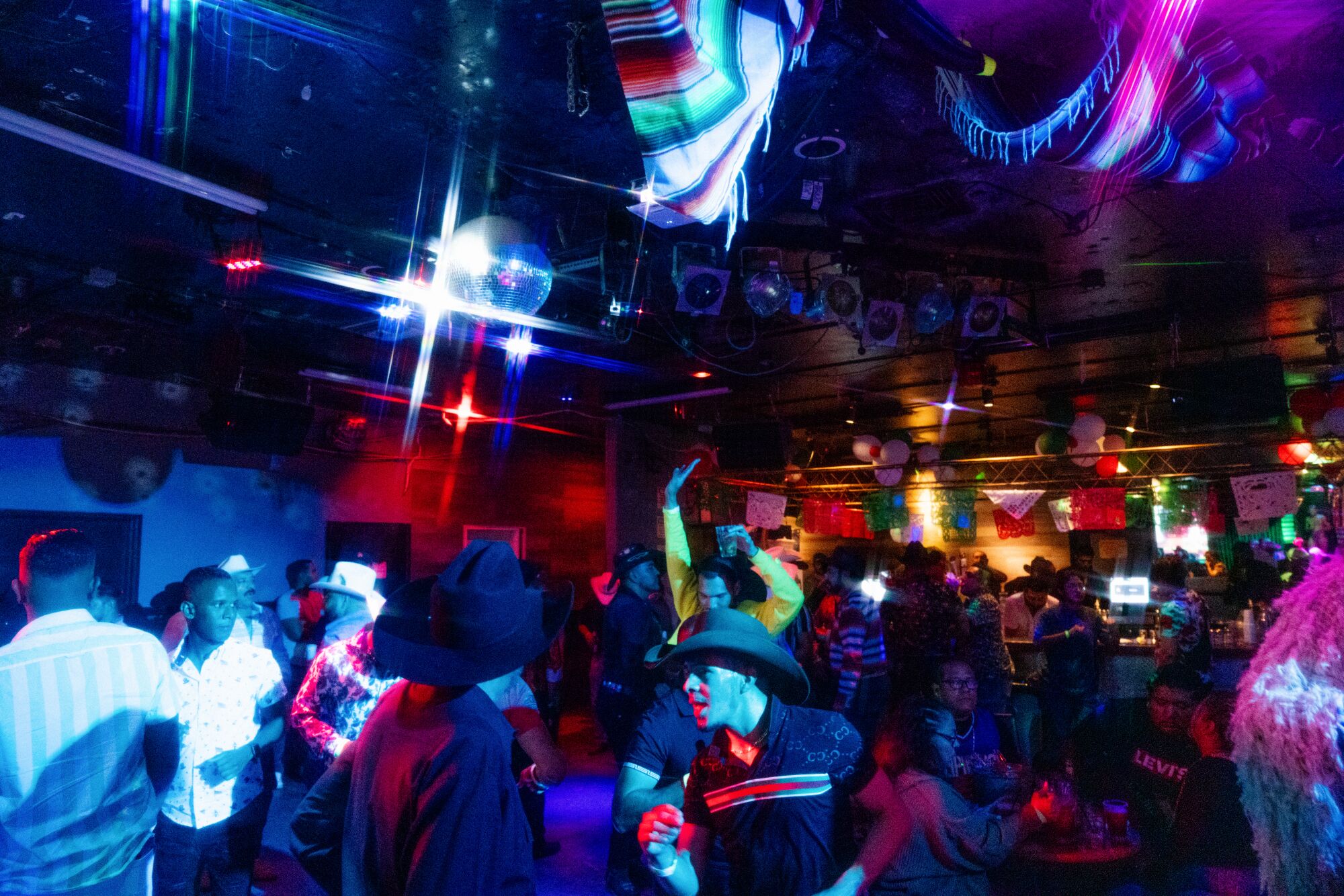 Patrons dance to club music on the second floor of Club Tempo.