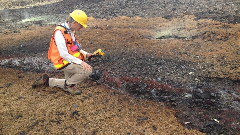 A U.S. Geological Survey scientist takes measurements at the Kilauea volcano in Hawaii on June 21.