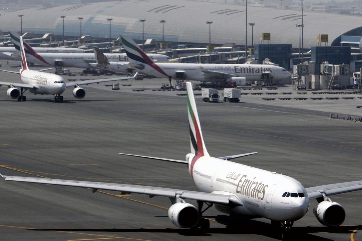 Emirates passenger jets taxi on the tarmac at Dubai International airport in Dubai, United Arab Emirates. Three U.S. carriers and flight attendants, pilots and other workers say Middle Eastern airlines have an unfair competitive advantage.