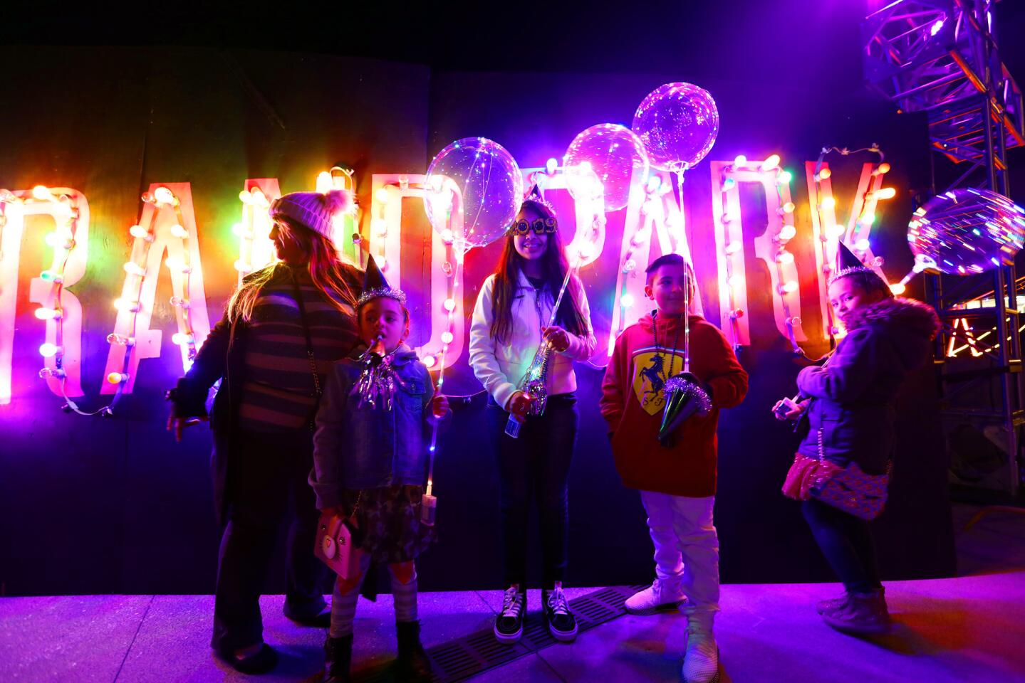 The Gonzalezes and a friend, right, get festive at the New Year's Eve event at L.A.'s Grand Park.