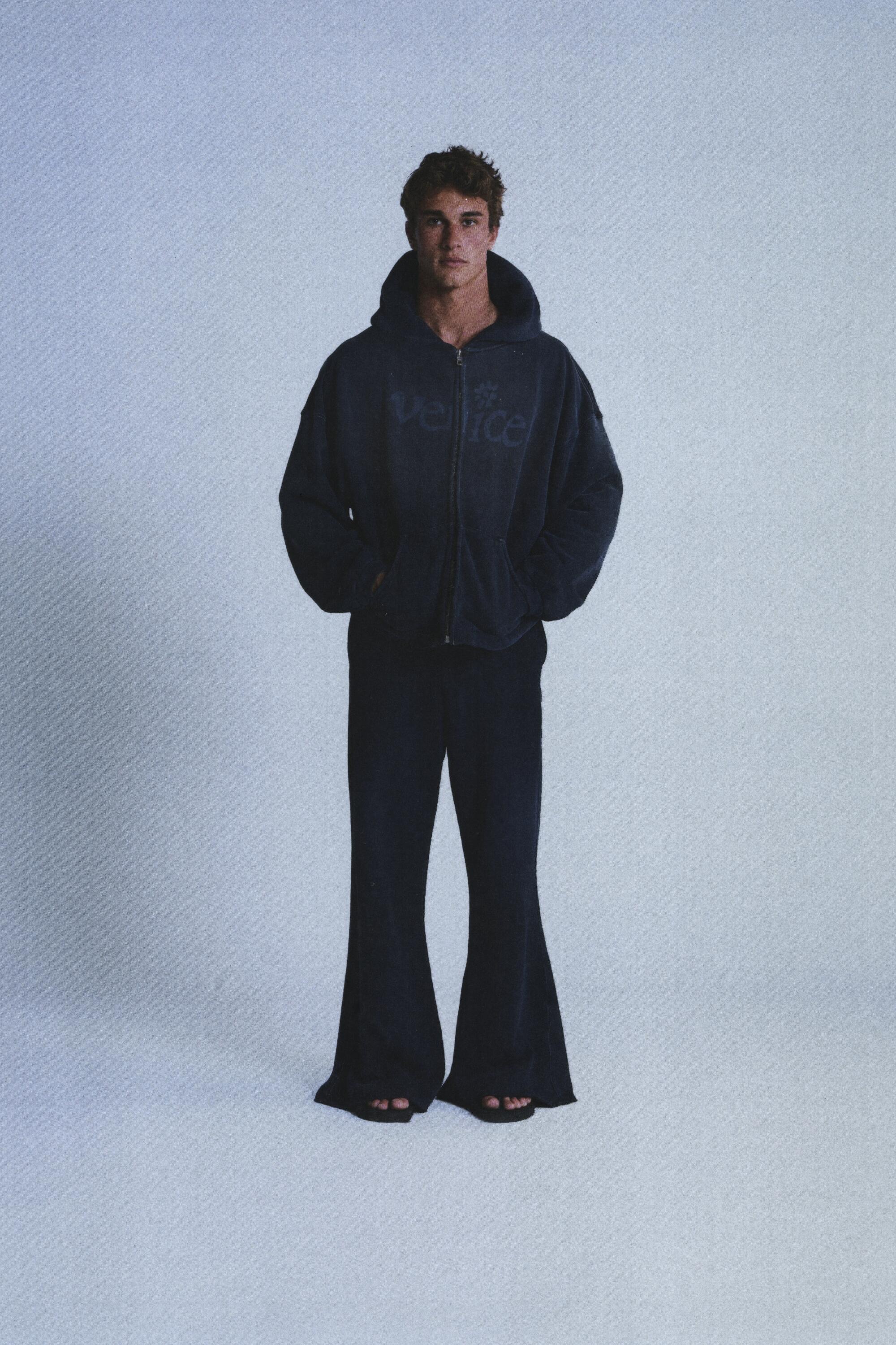 model wearing an ERL hoodie and flared pants