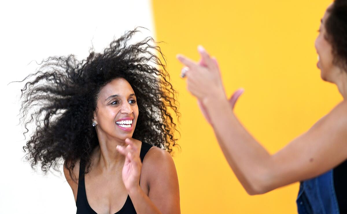 Chloe Arnold, left, rehearses with sister Maud in downtown Los Angeles.