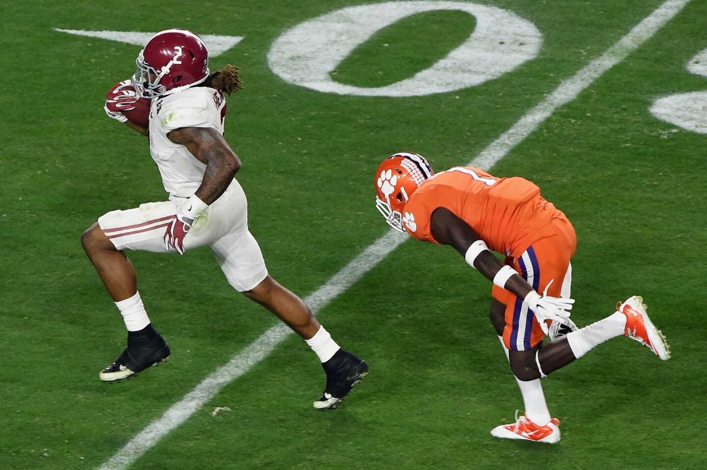 Alabama running back Derrick Henry runs for a 50-yard touchdown in the first quarter as Clemson safety Jayron Kearse can't make the tackle.