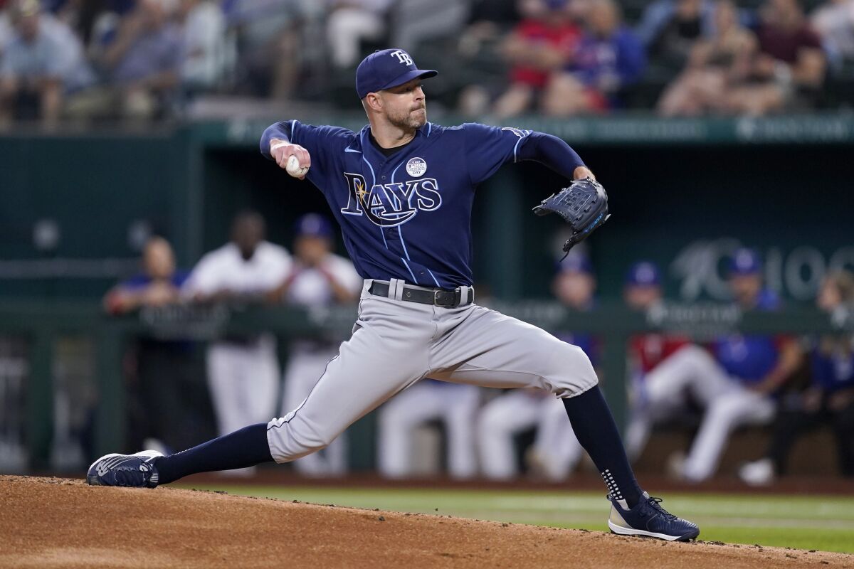 Tampa Bay Rays starting pitcher Corey Kluber throws to the Texas Rangers in the first inning of a baseball game, Thursday, June 2, 2022, in Arlington, Texas. (AP Photo/Tony Gutierrez)