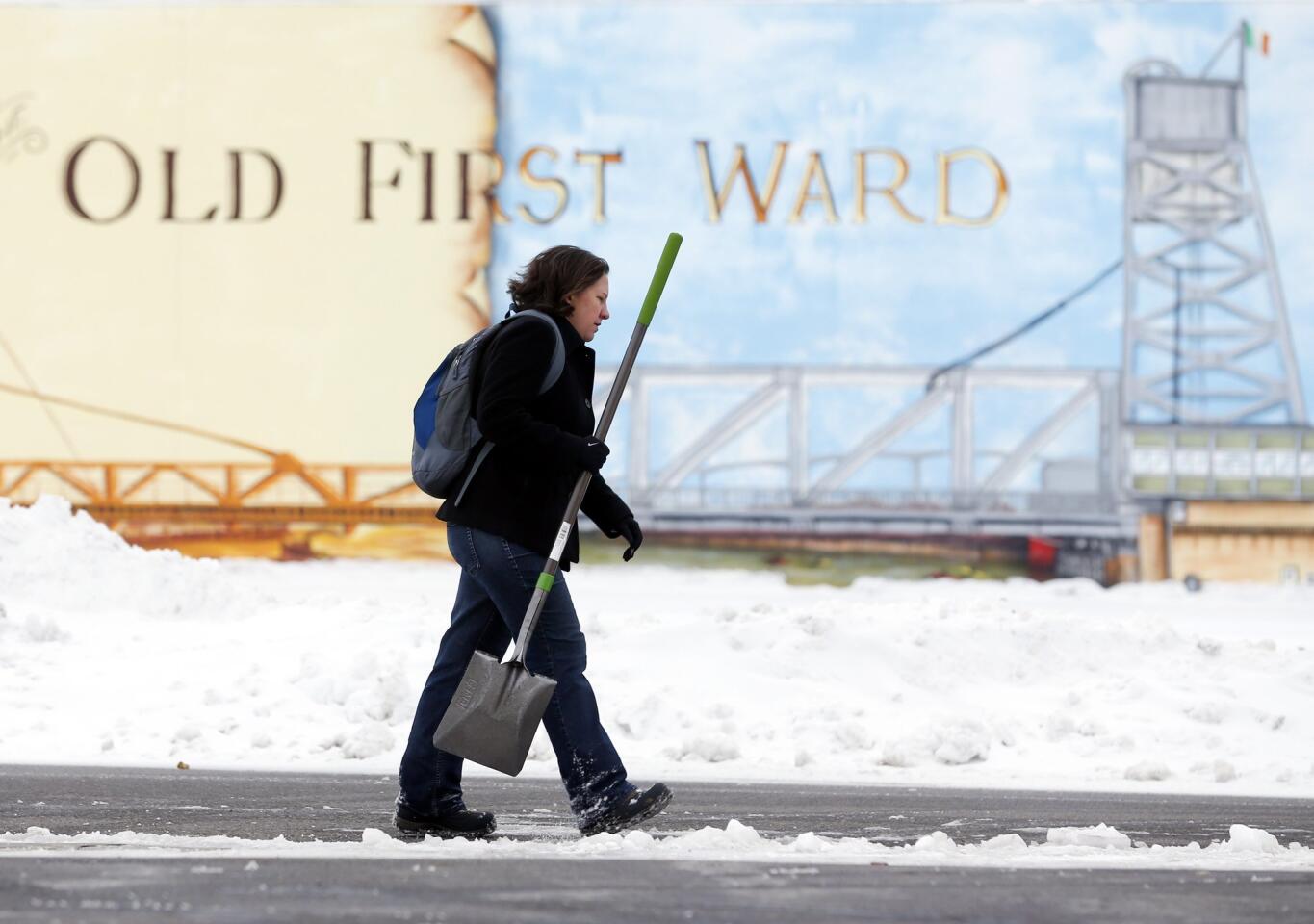 Beth Bragg carries a snow shovel to the Old First Ward Community Center in Buffalo, N.Y.
