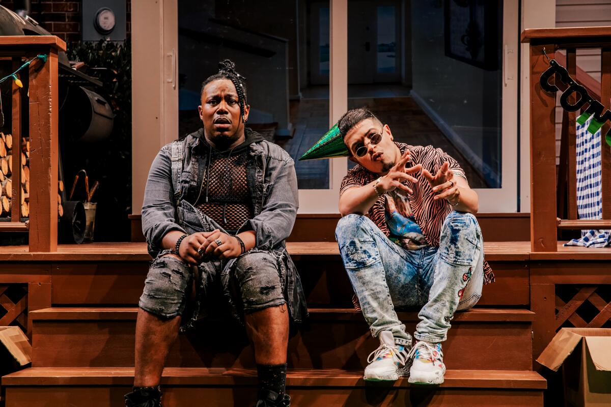 Two characters sit on the steps of a porch in "Fat Ham" at the Geffen Playhouse.