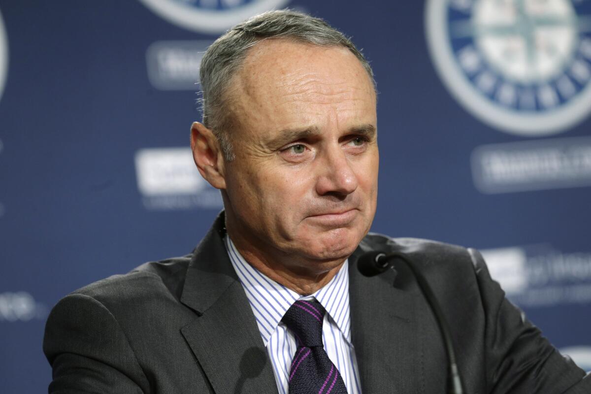 MLB Commissioner Rob Manfred talks to reporters before Wednesday's Angels/Mariners game in Seattle.