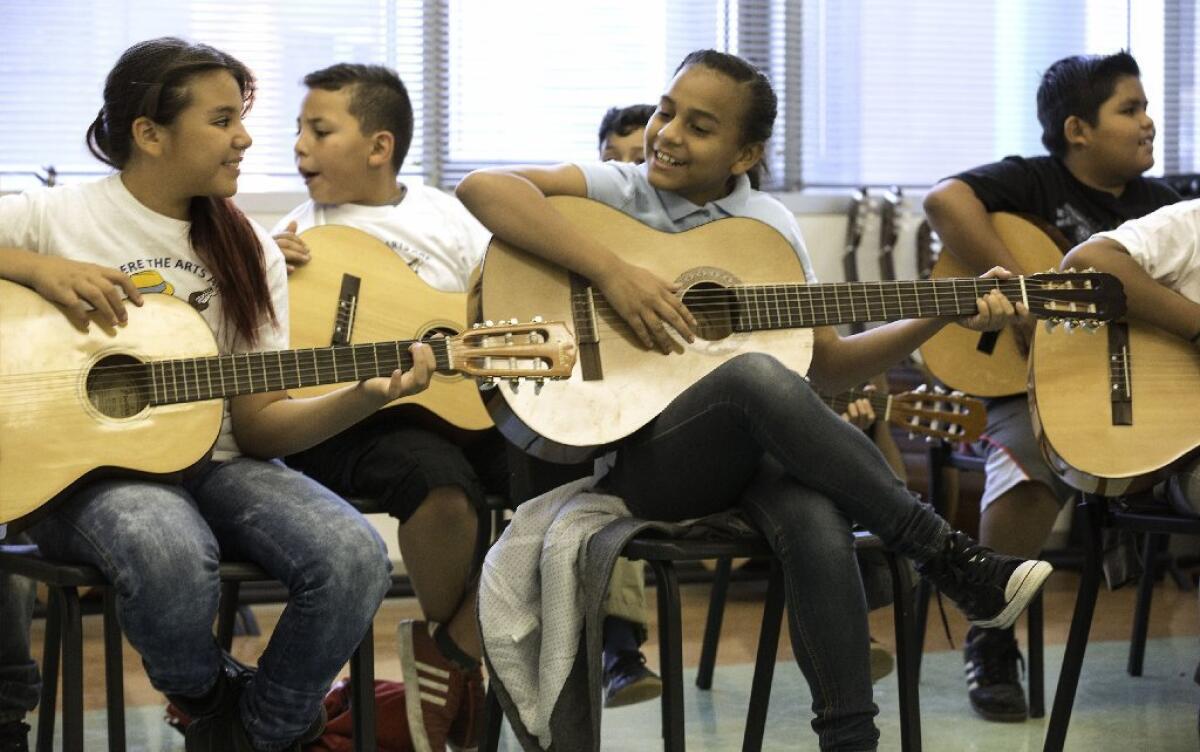 Students play guitars at Carlos Santana Arts Academy in North Hills.