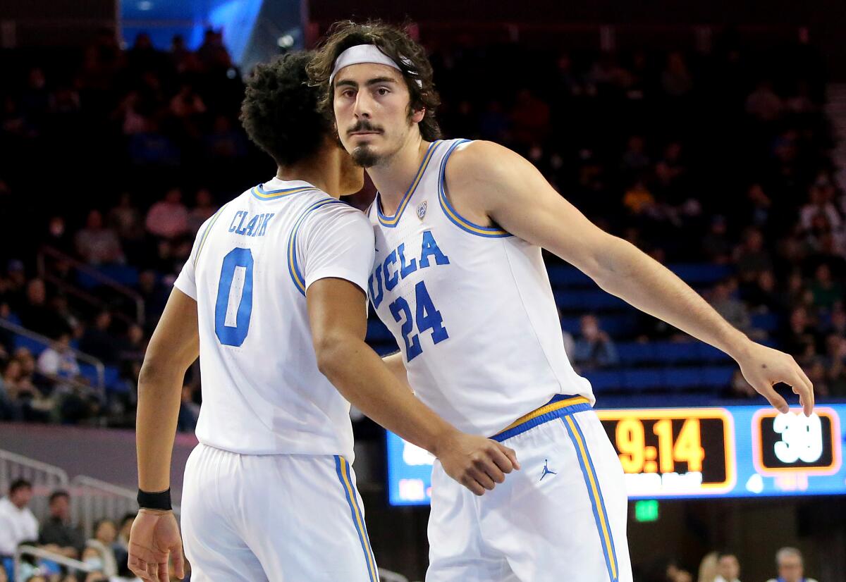 UCLA guard Jaime Jaquez Jr. is congratulated by teammate Jaylen Clark after scoring and getting fouled.