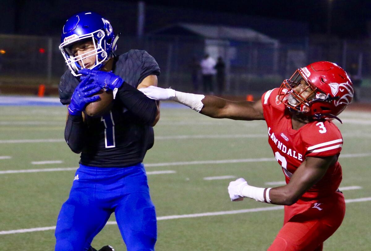 Culver City receiver Tanner Duve makes a catch behind Lawndale defender Ma’Kai Williams on Friday.
