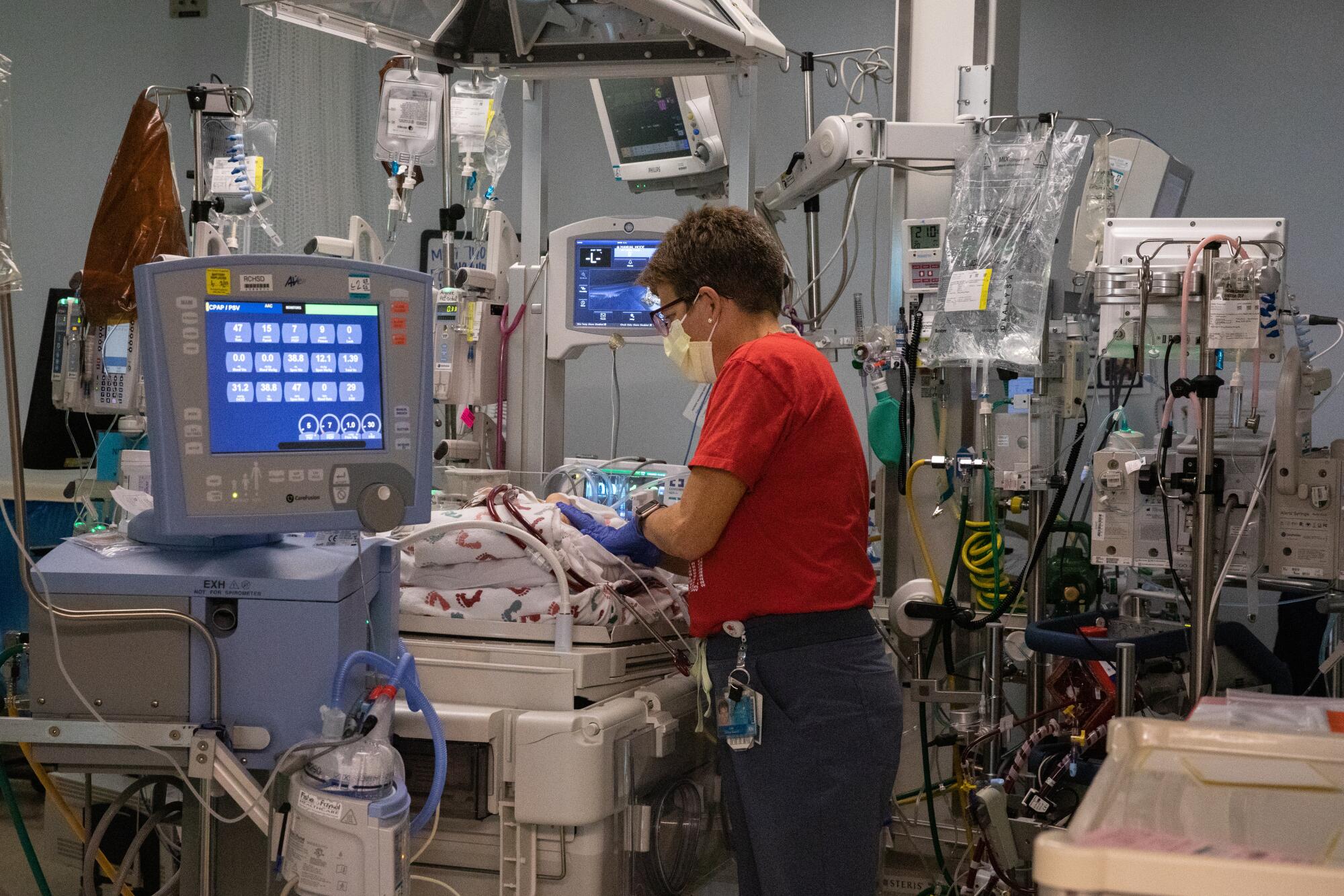 La enfermera diplomada Lisa Hayes prepara a un bebé prematuro para una transfusión de sangre 