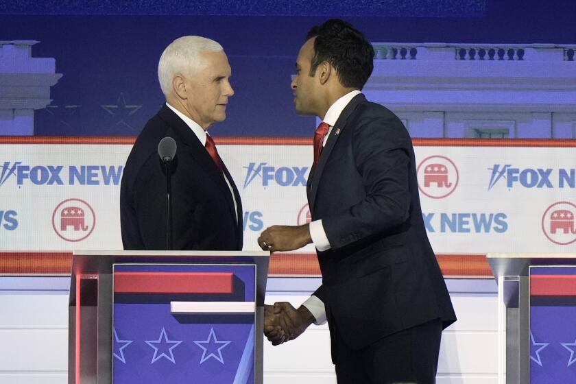 Businessman Vivek Ramaswamy shakes hands with former Vice President Mike Pence after a Republican presidential primary debate hosted by FOX News Channel Wednesday, Aug. 23, 2023, in Milwaukee. (AP Photo/Morry Gash)