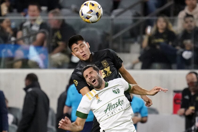 Portland Timbers midfielder Diego Valeri, bottom, is defended by Los Angeles FC defender Marco Farfan during the second half of an MLS soccer match Wednesday, Sept. 29, 2021, in Los Angeles. (AP Photo/Marcio Jose Sanchez)