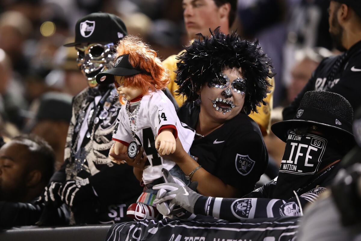 Fans look on from the stands during the NFL game between the Oakland Raiders and the Los Angeles Rams at Oakland-Alameda County Coliseum.