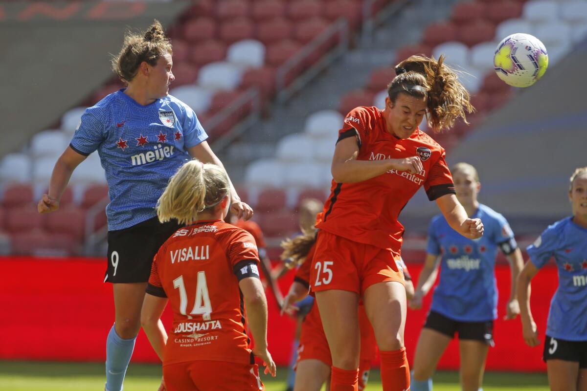 Chicago Red Stars' Savannah McCaskill heads the ball in the direction of the goal as Houston Dash's Katie Naughton defends.