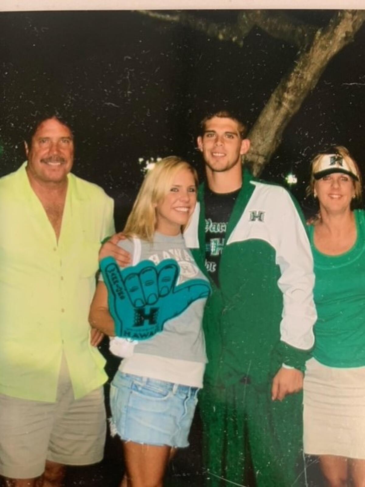 Colt Brennan, second from right, poses for a photo with his father Terry, sister Chanel, center, and mother Betsy.
