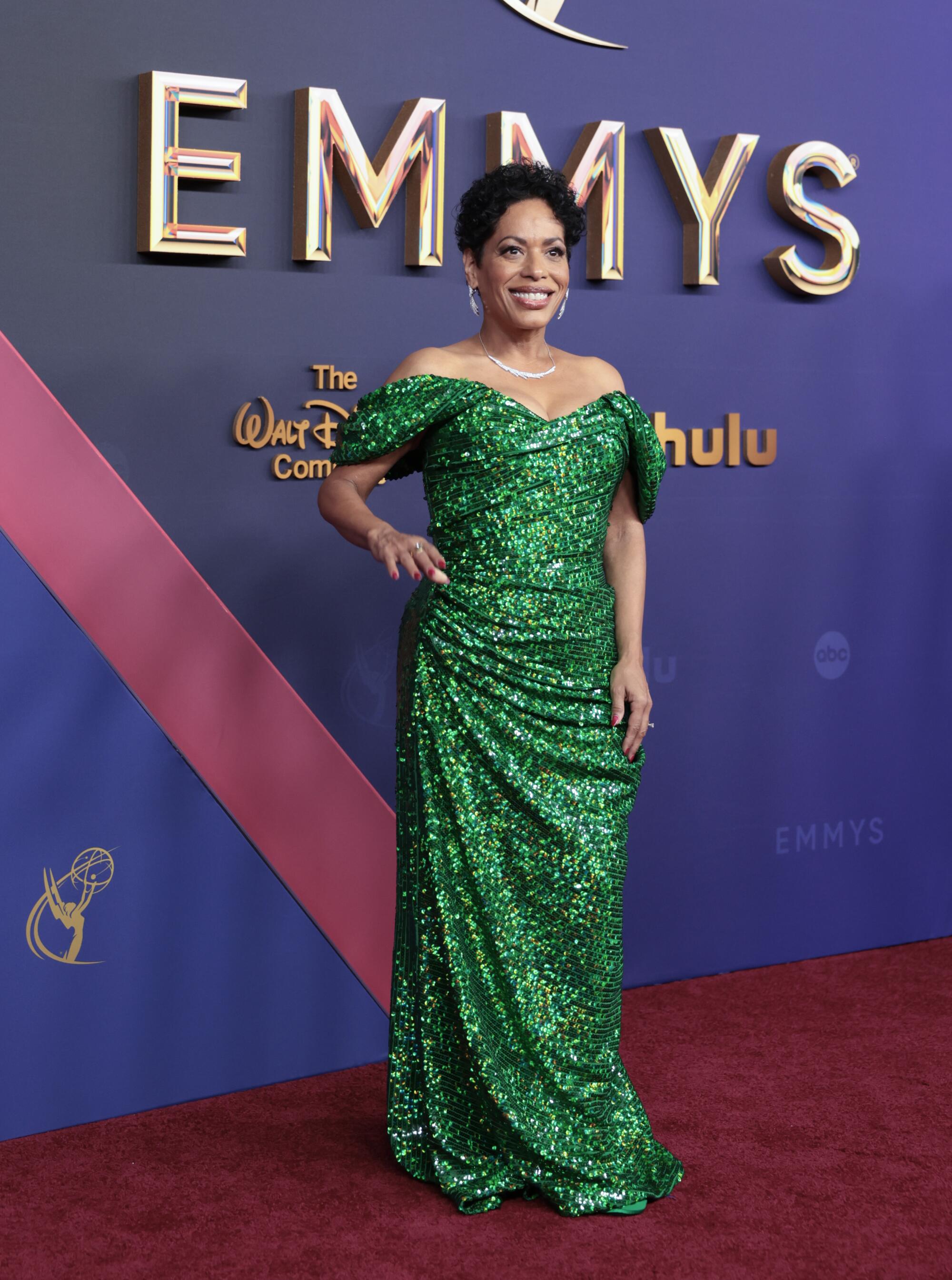 Liza Colón-Zayas wears a sequin off-the-shoulder green gown.