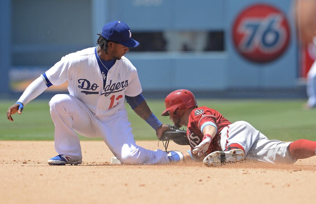 Hanley Ramirez tags out Arizona's Cody Ross at second base on a throw from Yasiel Puig during the Dodgers' 6-3 loss Sunday to the Diamondbacks.