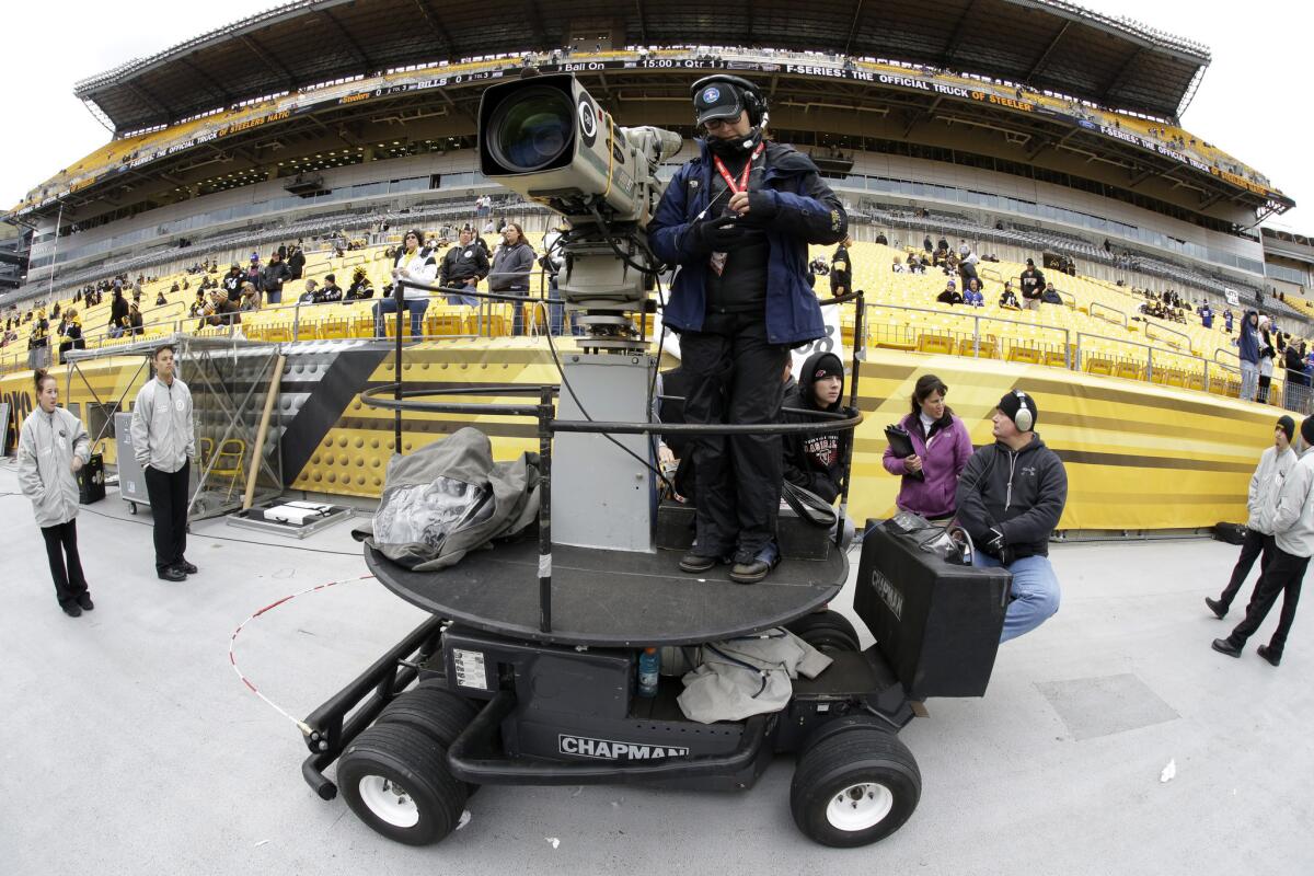 A CBS camera operator prepares to cover a Pittsburgh Steelers-Buffalo Bills game in Pittsburgh on Nov. 10, 2013.