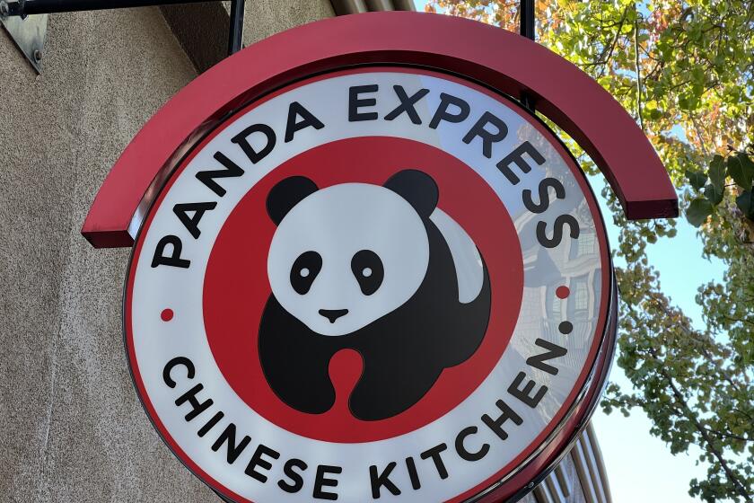 Close-up of a red, black, and white 'Panda Express Chinese Kitchen' restaurant sign