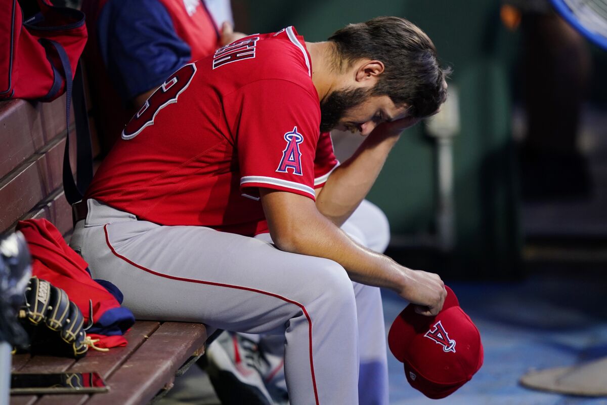Angels starting pitcher Chase Silseth sits in the dugout after being pulled in the second inning.