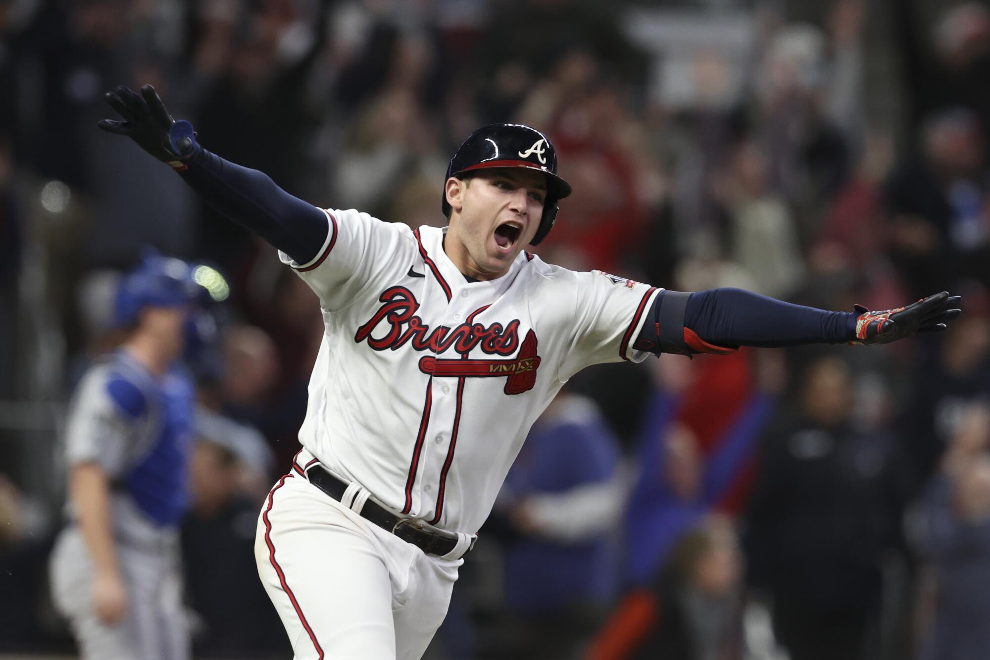 Braves' Austin Riley reacts after hitting a walk off RBI single to score Ozzie Albies during the ninth inning