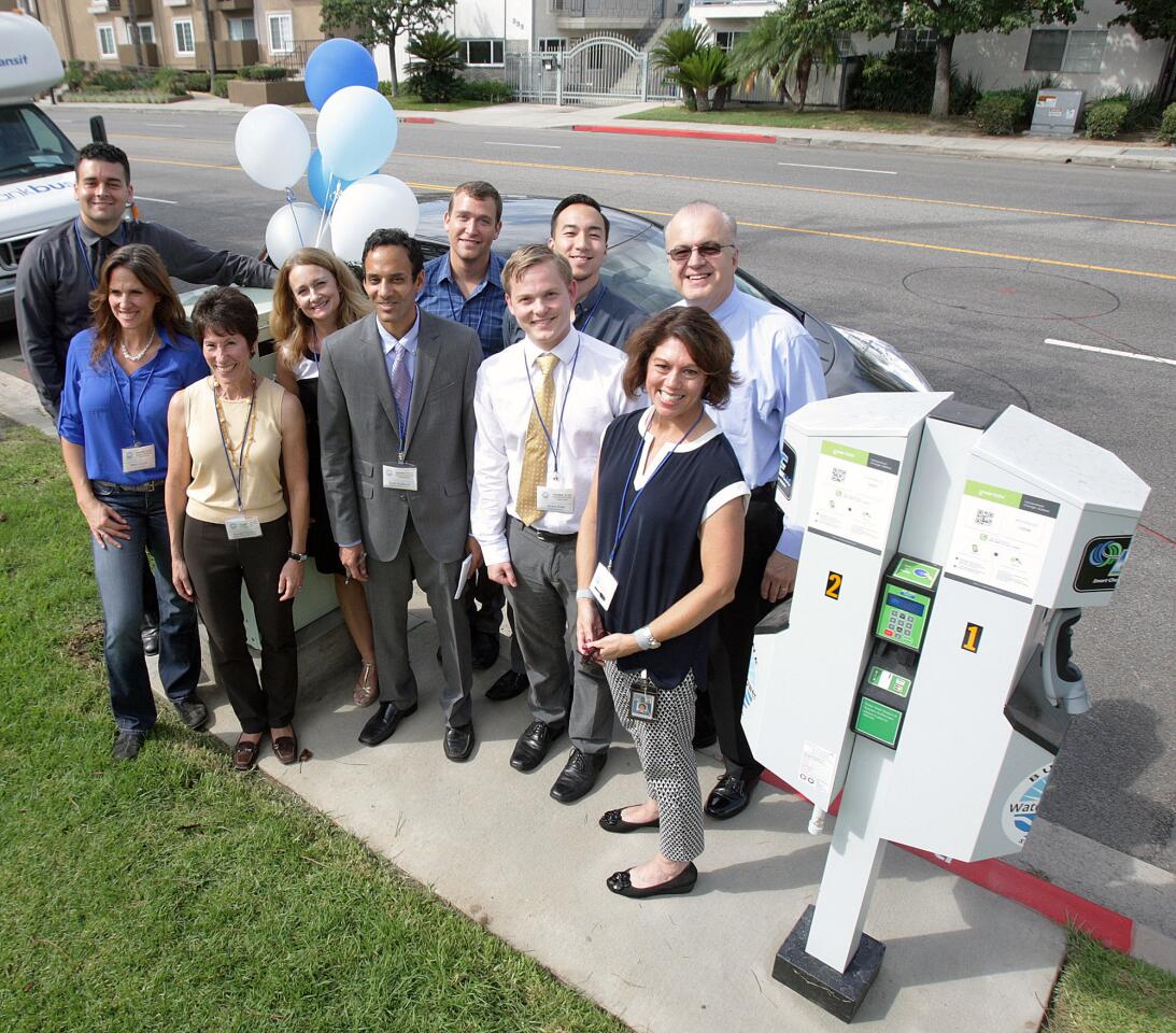 The Burbank Water and Power project team poses for a group photo at a demonstration and ribbon cutting for one of the eight dual-charger, electric-vehicle charging stations on Buena Vista Avenue in front of the Buena Vista Branch Library in Burbank on Tuesday, Aug. 25, 2015.