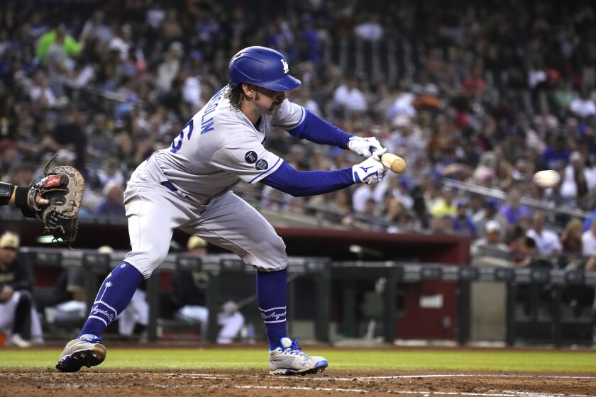 Tony Gonsolin puts down a sacrifice bunt against the Diamondbacks in the fifth inning Friday.