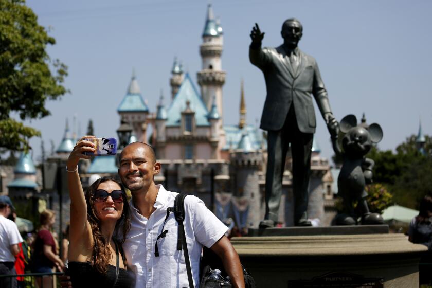 A couple takes a selfie at Disneyland