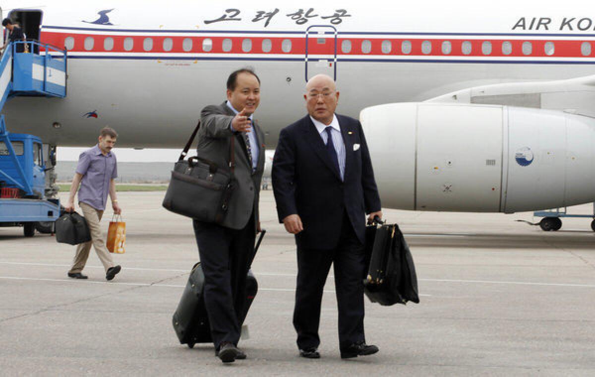 Isao Iijima, right, a top advisor to Japan's prime minister, arrives in Pyongyang, North Korea, on Tuesday for an unannounced visit.