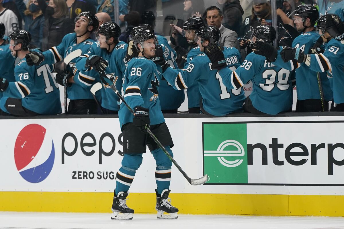 San Jose Sharks left wing Jasper Weatherby (26) is congratulated by teammates after scoring against the San Jose Sharks during the second period of an NHL hockey game in San Jose, Calif., Saturday, Oct. 16, 2021. (AP Photo/Jeff Chiu)