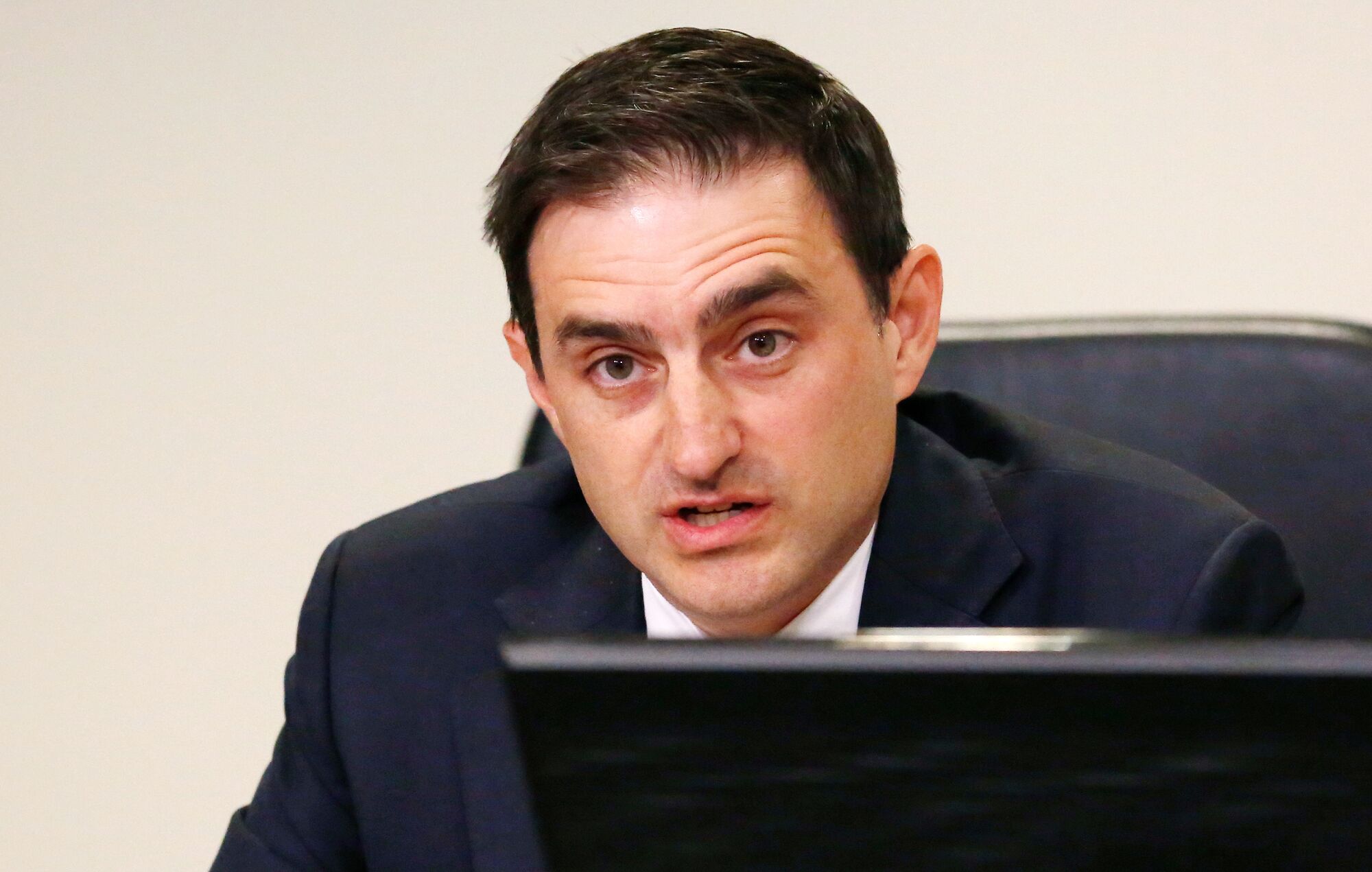 Andrew Glazier sits at a meeting table.
